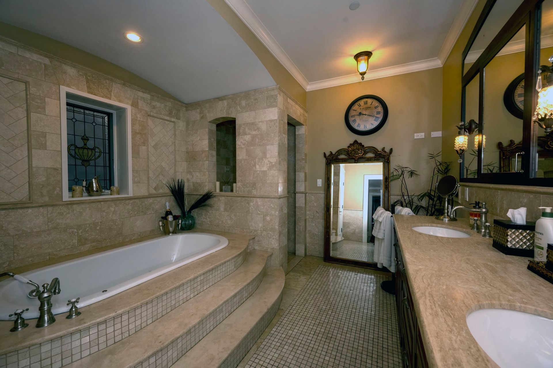 A bathroom with a jacuzzi tub and a window.