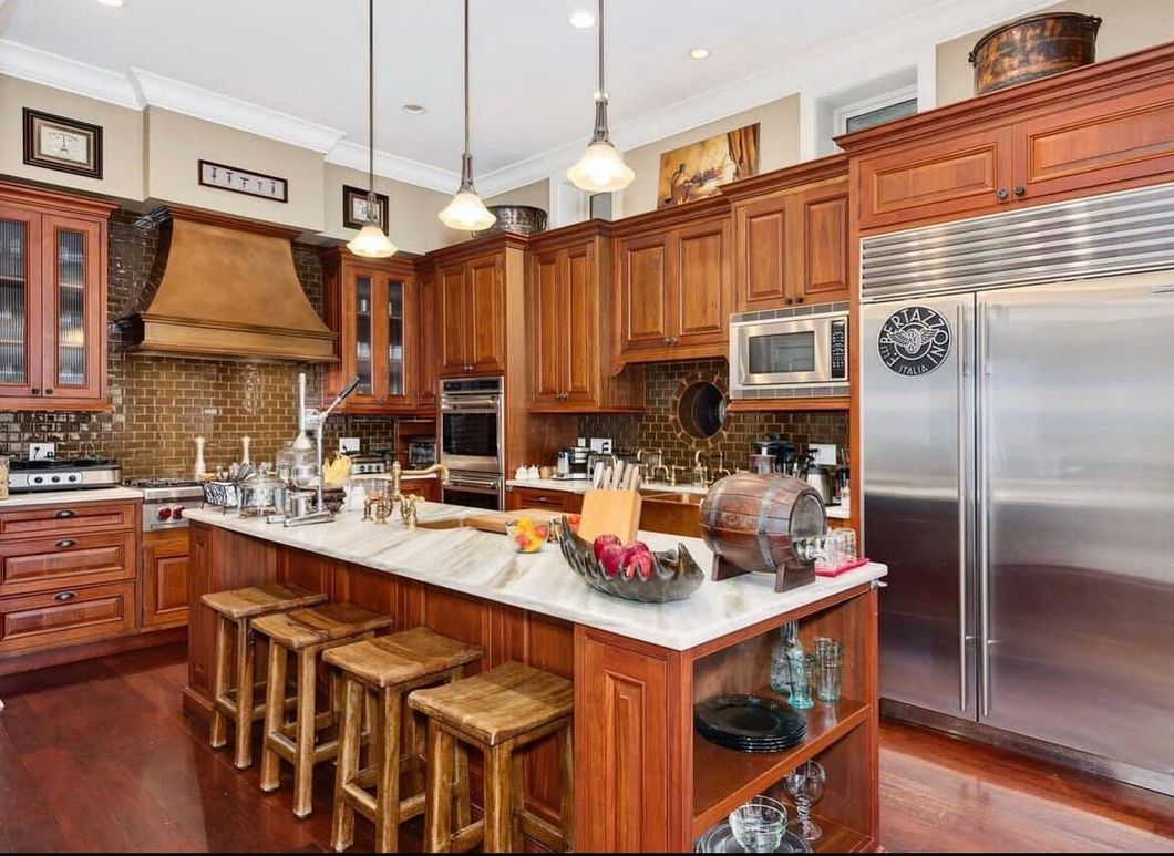 A kitchen with stainless steel appliances and wooden cabinets