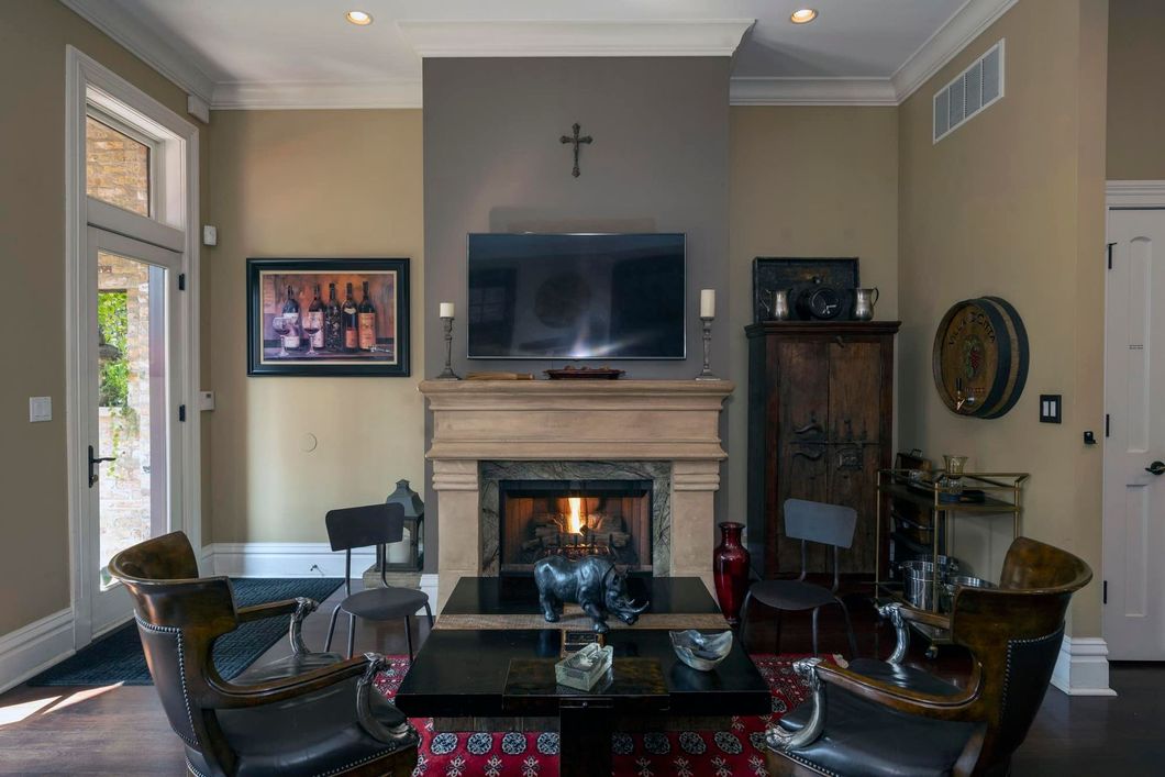 A living room with a fireplace and a flat screen tv.