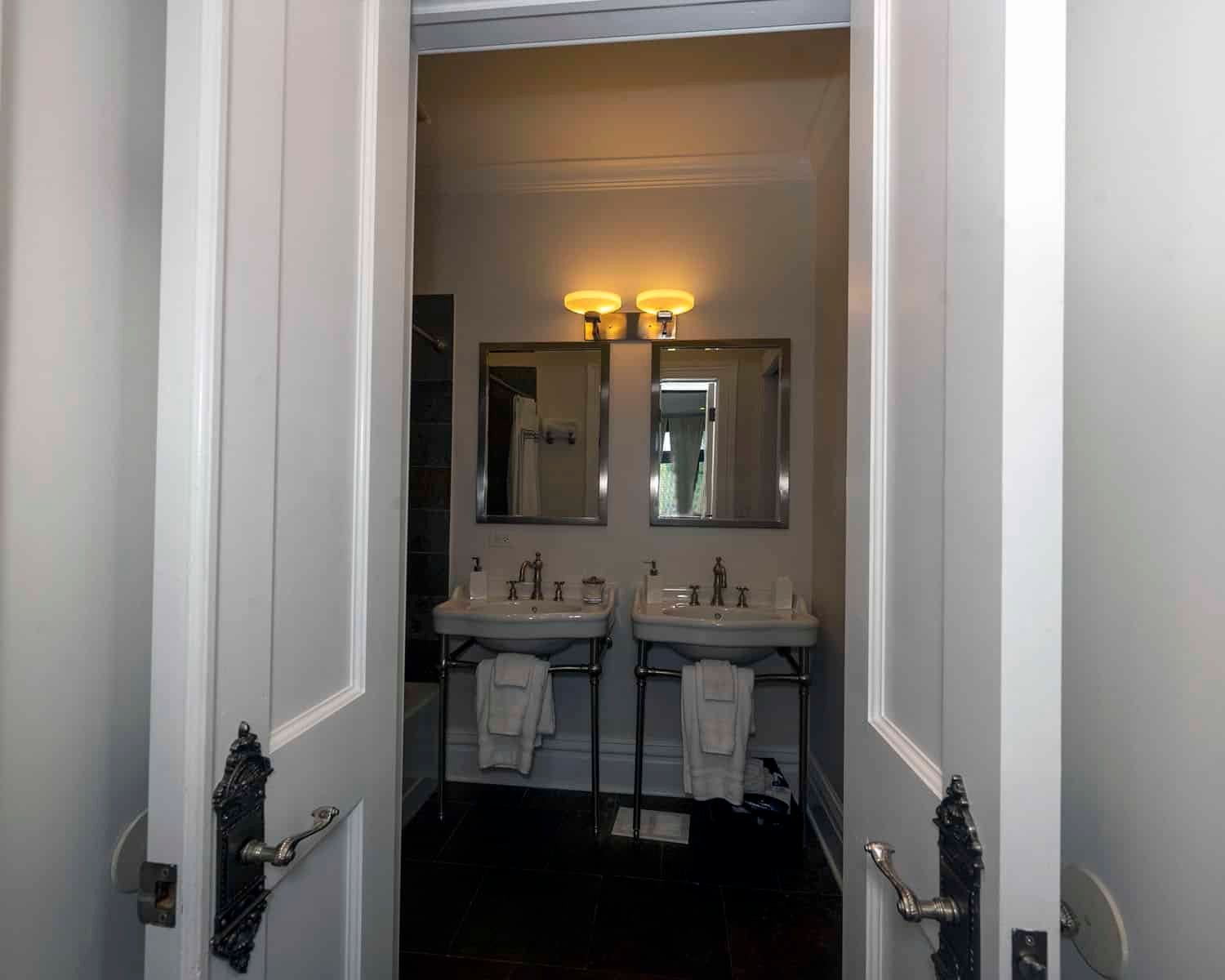 A bathroom with two sinks and two mirrors.