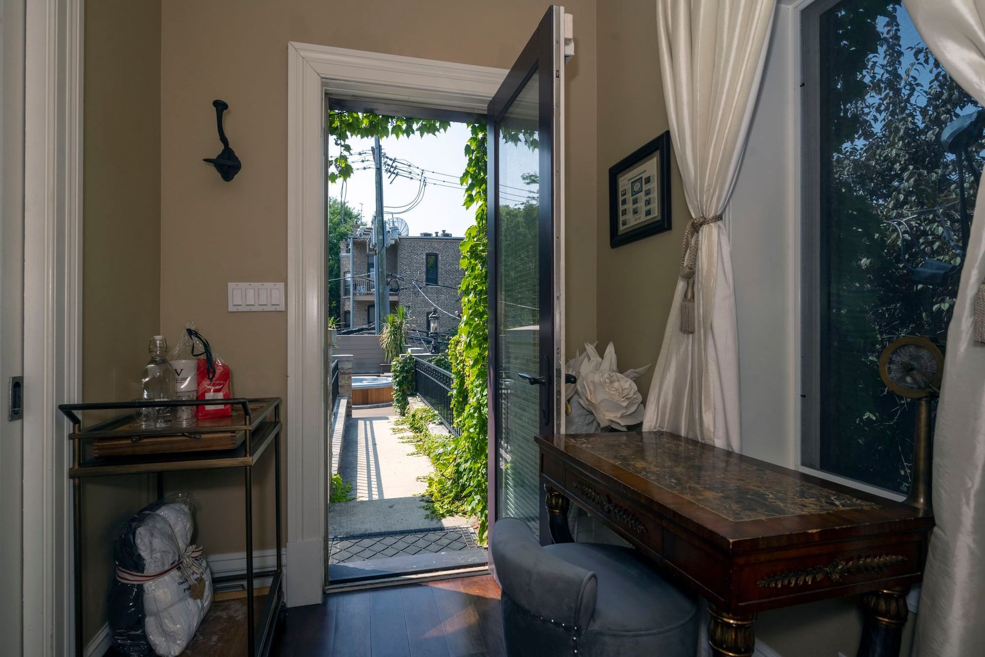 A room with a desk and chair and a door that is open.