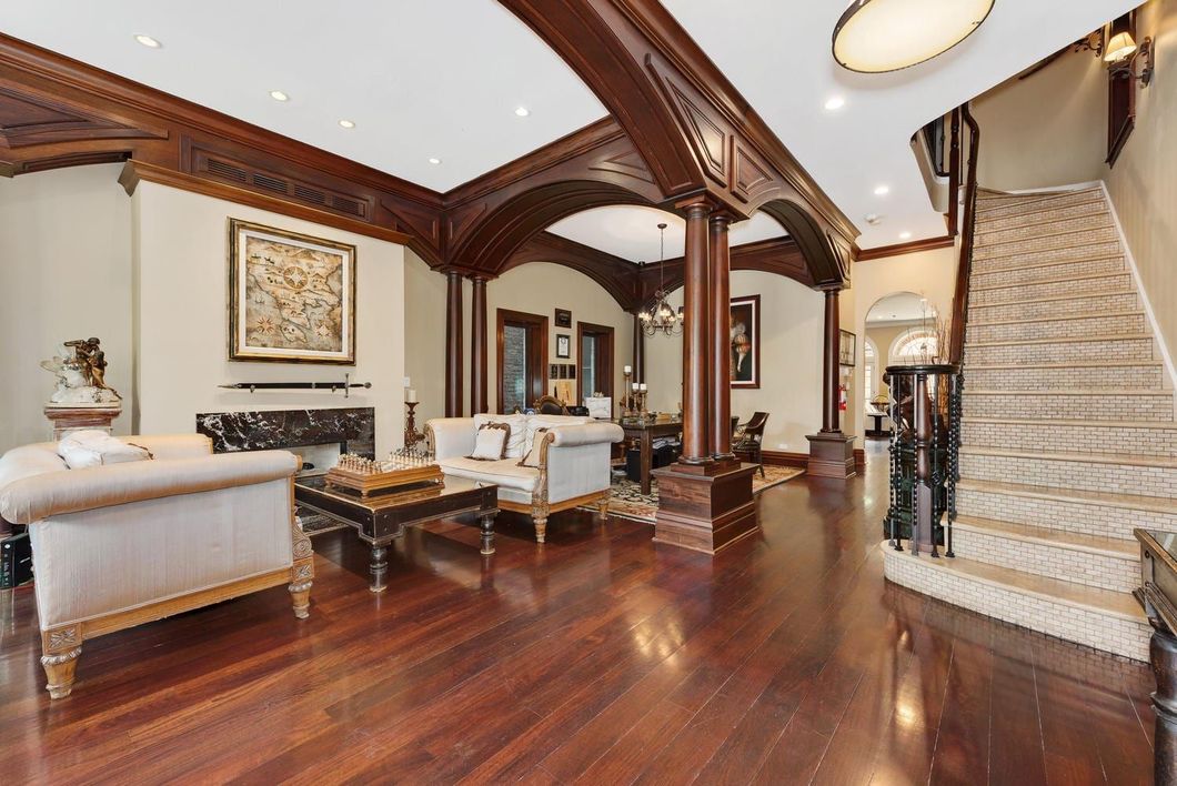 A living room with hardwood floors and a staircase