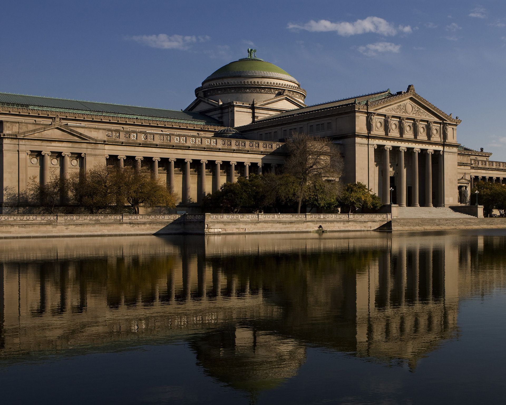 A large building is reflected in a body of water