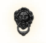 A black door knocker with a lion 's head on it on a white background.