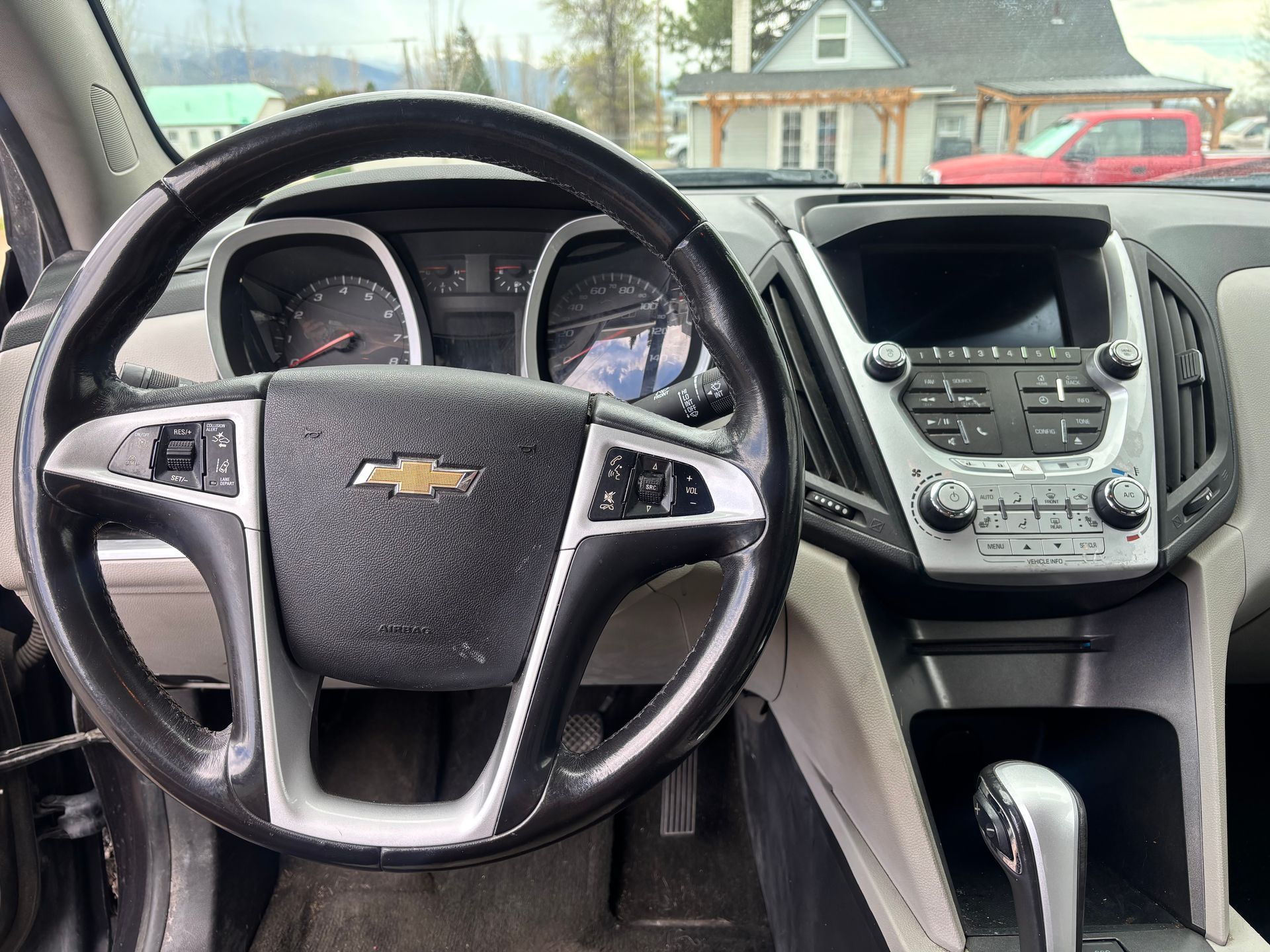 Chevrolet car interior with steering wheel, dashboard, center console, and gear shift