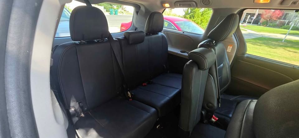 Back seat of a car with black upholstery and child safety seats installed