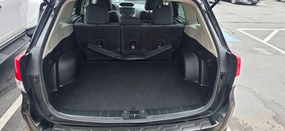 Open SUV trunk with empty cargo area and folded rear seats