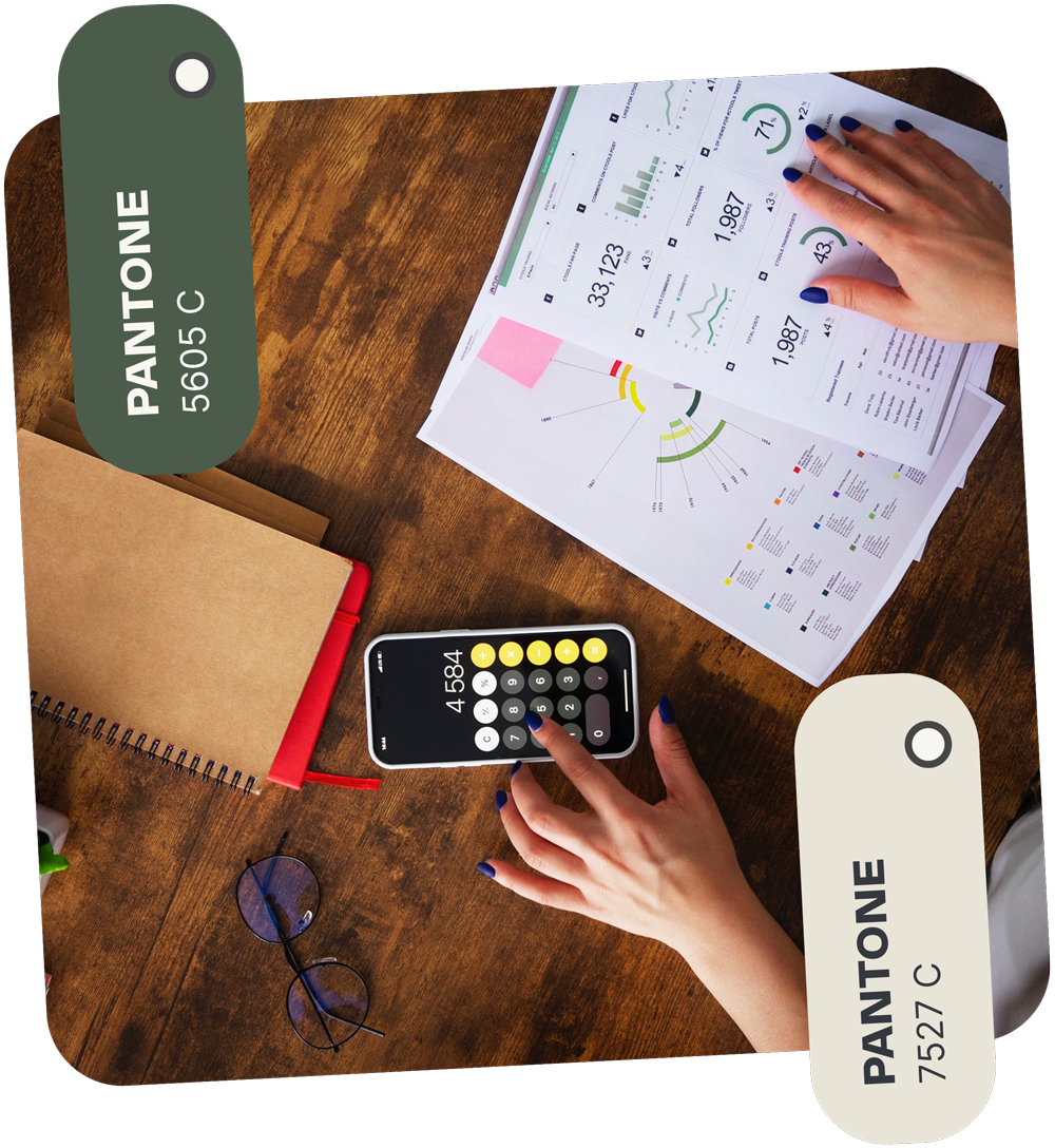 Person calculating on a phone with documents on a wooden desk; Pantone colors 5605 C and 7527 C.