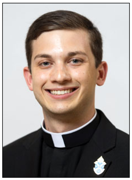 Portrait of a smiling man in a black clerical suit with a white collar and pin on lapel