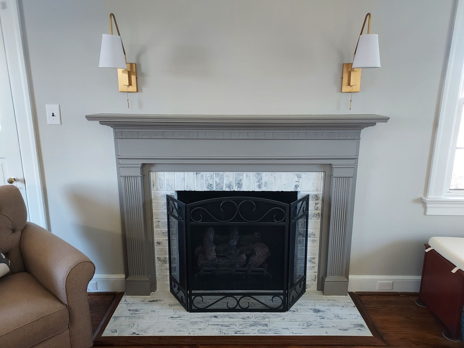 A living room with a fireplace and a chair.