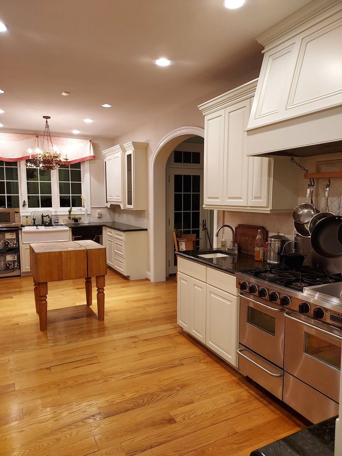A kitchen with stainless steel appliances and wooden floors