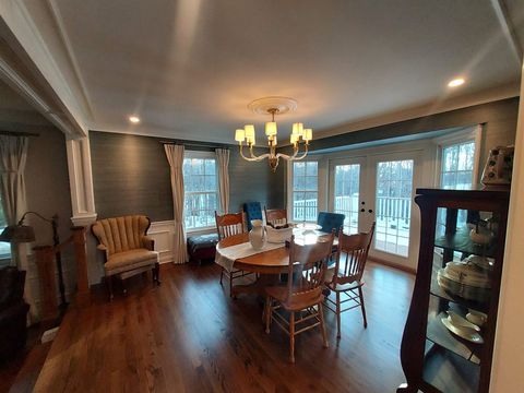 A dining room with a table and chairs and a chandelier