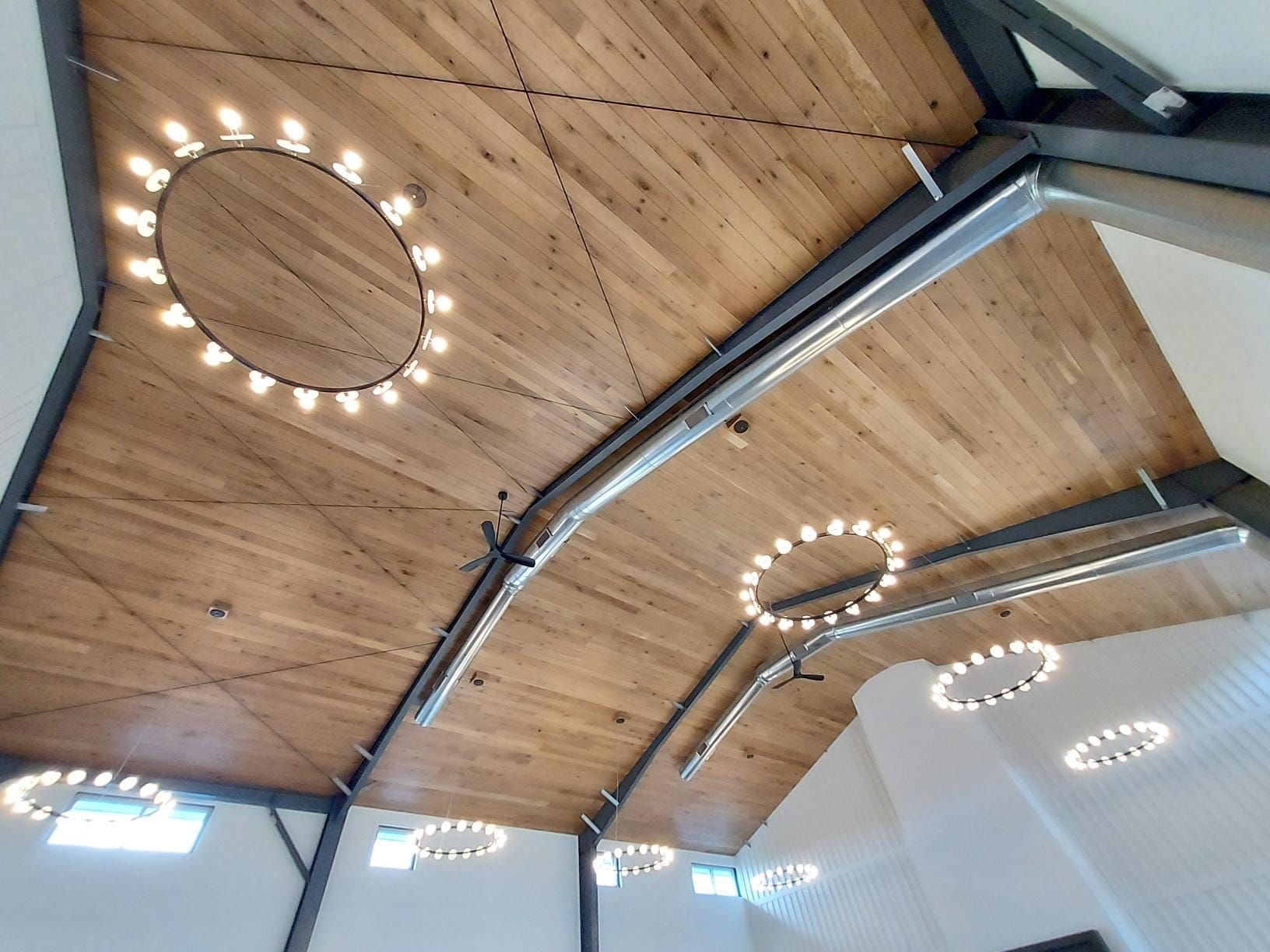 A wooden ceiling with a lot of lights hanging from it
