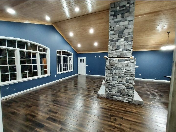 A living room with hardwood floors and a fireplace.