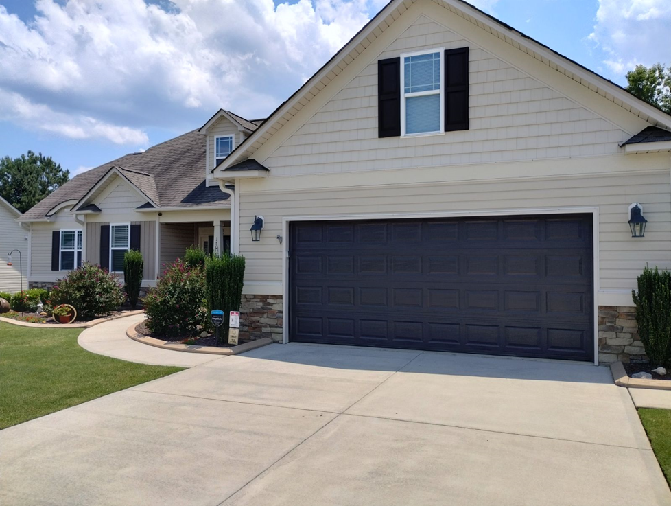 A white house with a black garage door — Raleigh, NC — Untied Painting, LLC