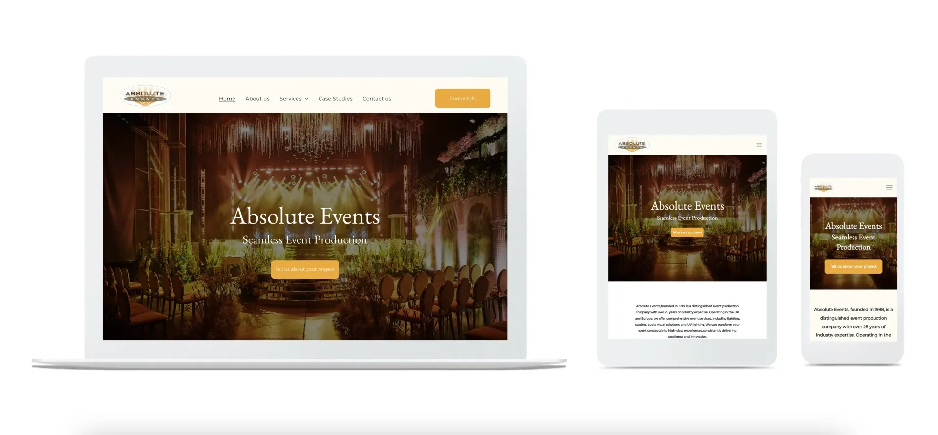 A person is sitting at a desk using a computer website and a laptop.