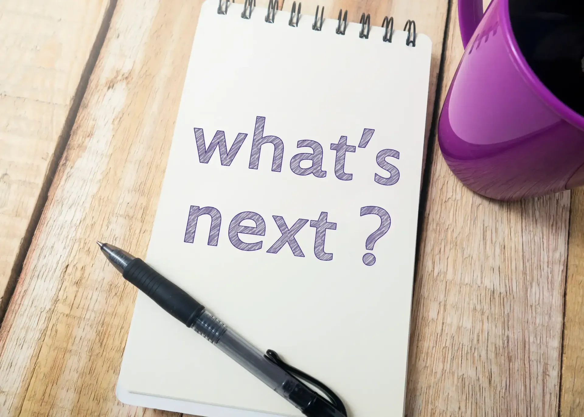 A notebook with the words what 's next written on it
