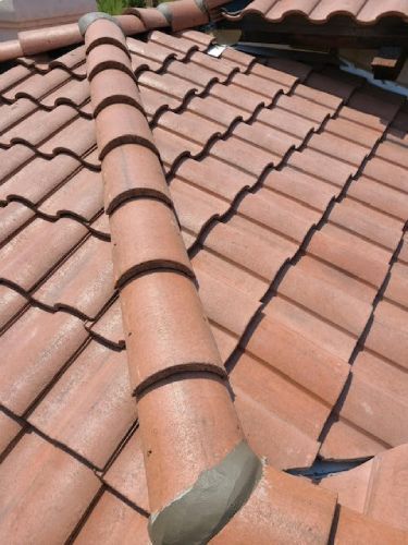 A roof with a broken tile on it