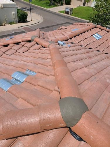 A roof with a lot of tiles and a street in the background
