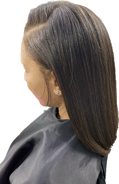 Woman with dark, straight hair, side part.