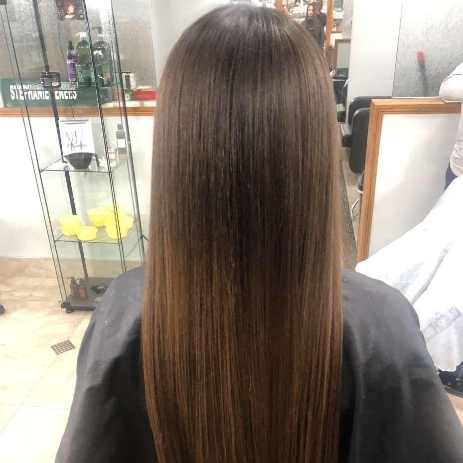 Long, straight brown hair styled after a salon treatment.