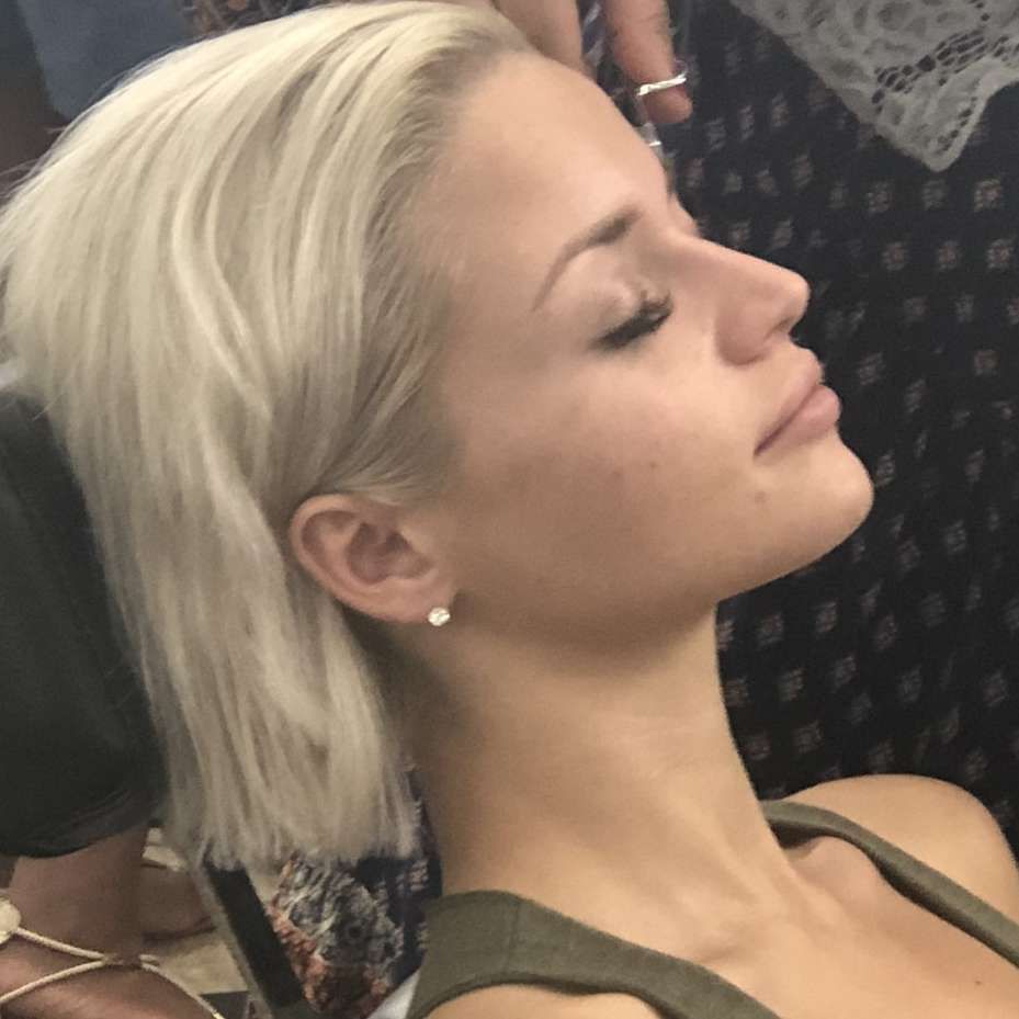 Blonde woman with short hair.