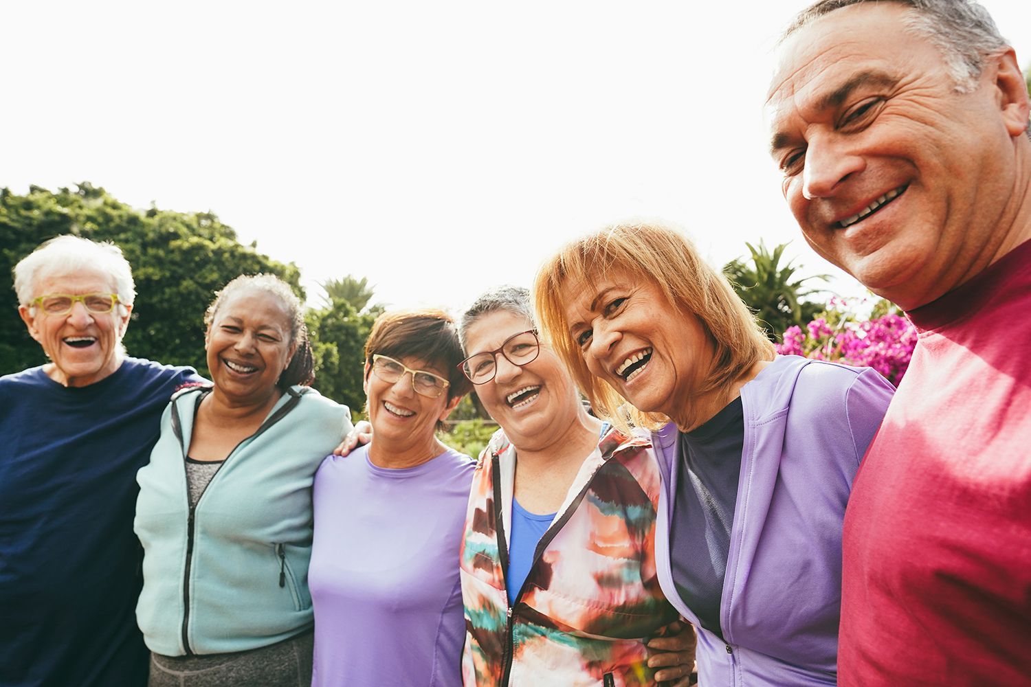 A group of older people are posing for a picture together and smiling.