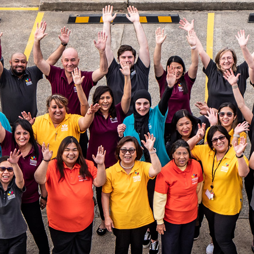 The FOCUS Connect team posing for a picture with their hands in the air