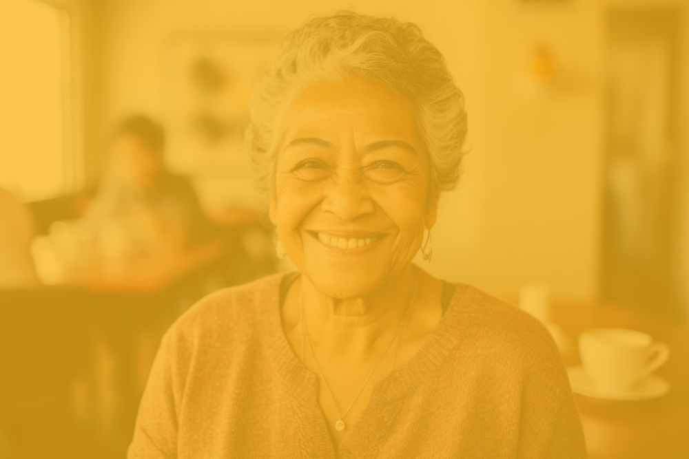 An elderly woman is smiling for the camera.