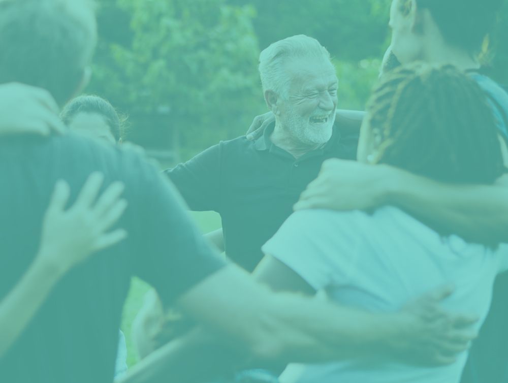 a group of people are hugging each other in a circle