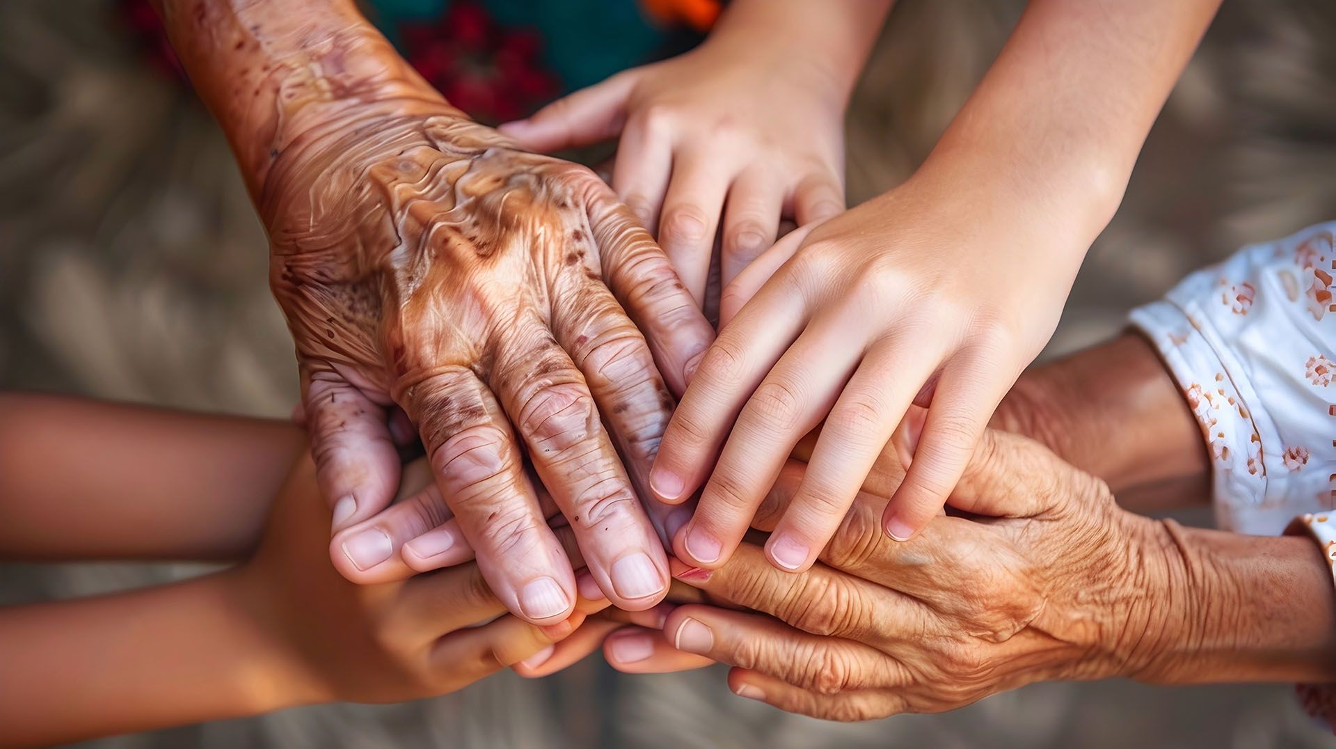 A group of people are putting their hands together.