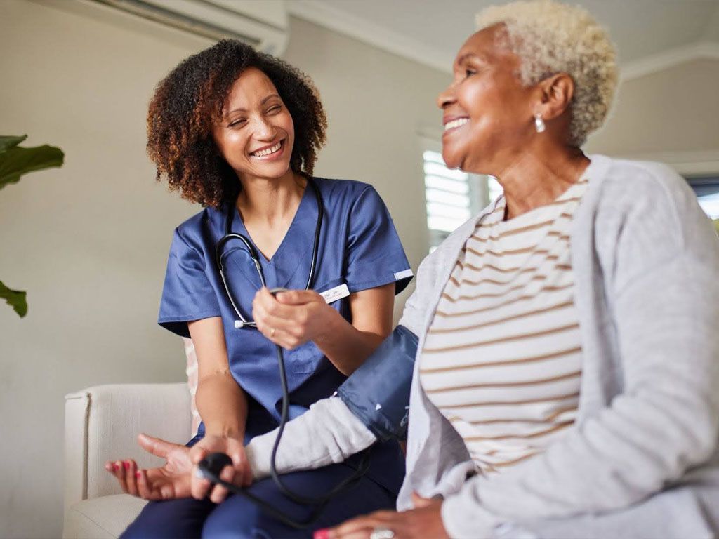 Nurse checking the blood pressure of an elderly woman