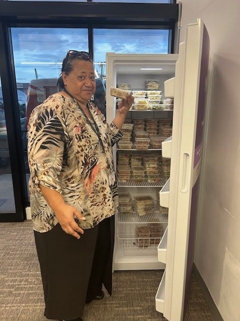 woman holding a food in front of a freezer