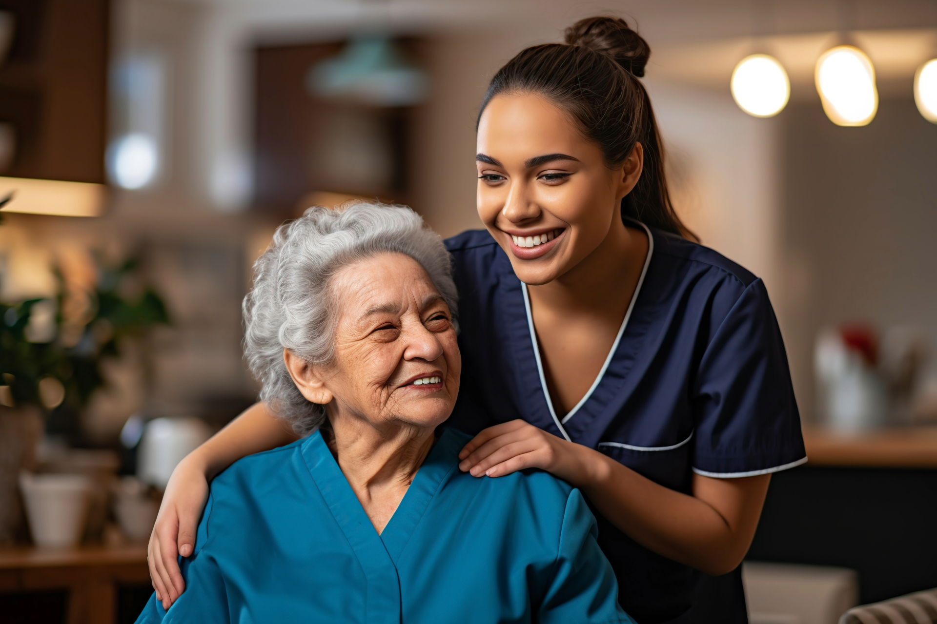 Older woman speaking with a carer at home kitchen table about personal care support and wellbeing