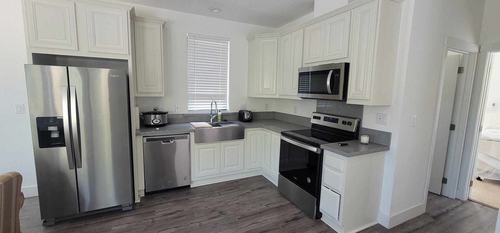 L Shaped Kitchen with Stainless Steel Appliances