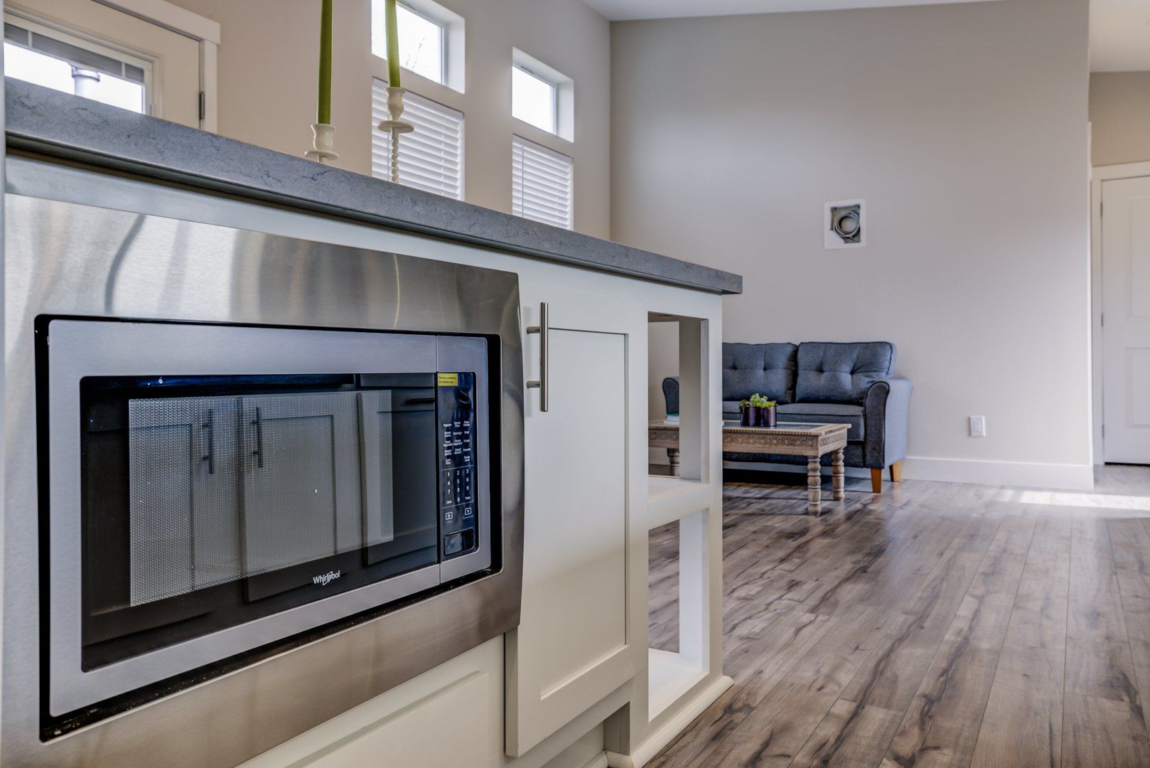 Stainless Steel Microwave and Counter with Loveseat Sofa in Background