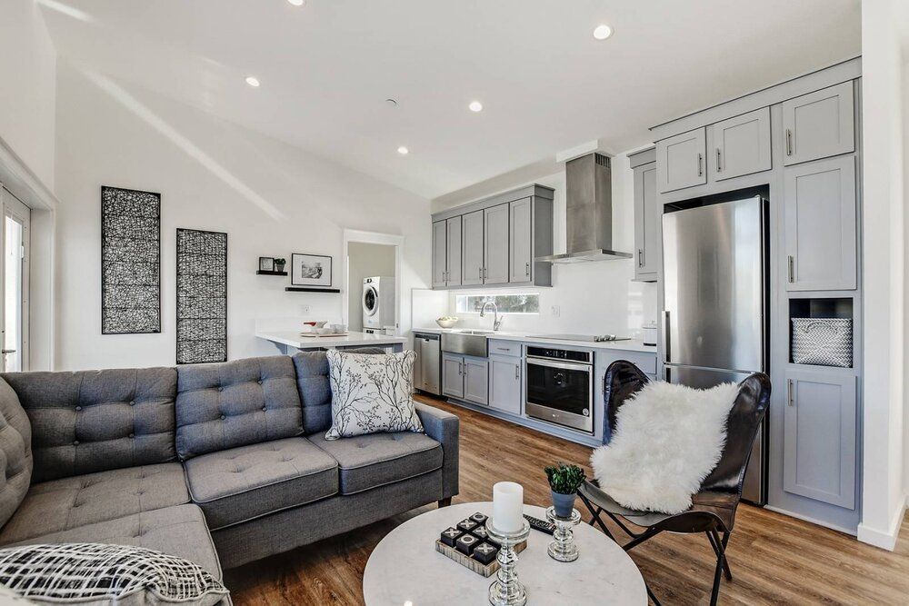 Sectional Sofa in Livingroom with Kitchen and Entryway in Background