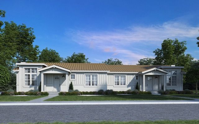 Perpetual Homes ADU: White duplex home with tan roof, front doors, windows, and green lawn on sunny day.