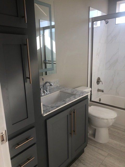 Toilet Between Vanity and Shower-Tub Combo