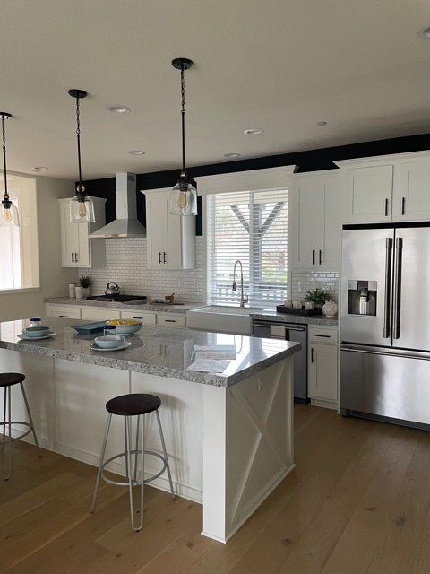 Kitchen with Stainless Steel Appliances and Islands with Seating