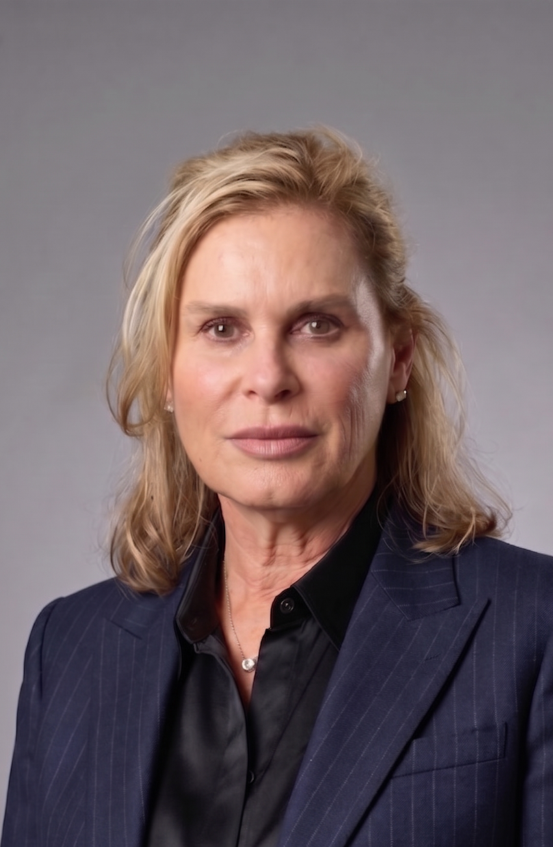 Katherine Noe Anderson, owner of Perpetual Homes ADU in Danville, CA. Has blonde hair, wearing a black top and blue jacket.