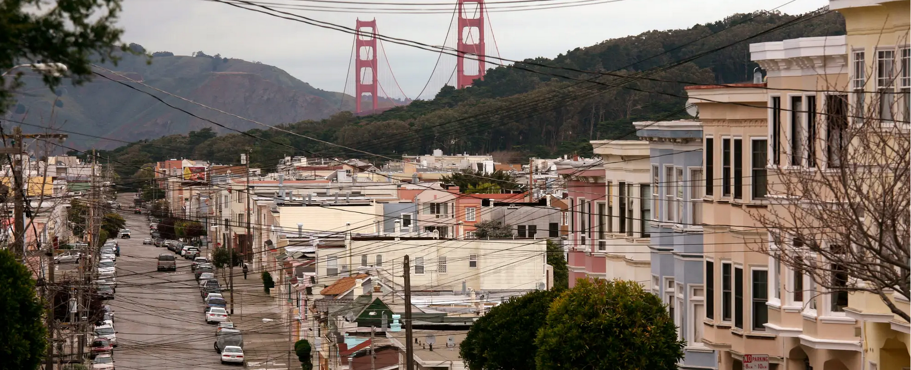 San Francisco Neighborhood with Powerlines and Golden Gate Bridge in Background