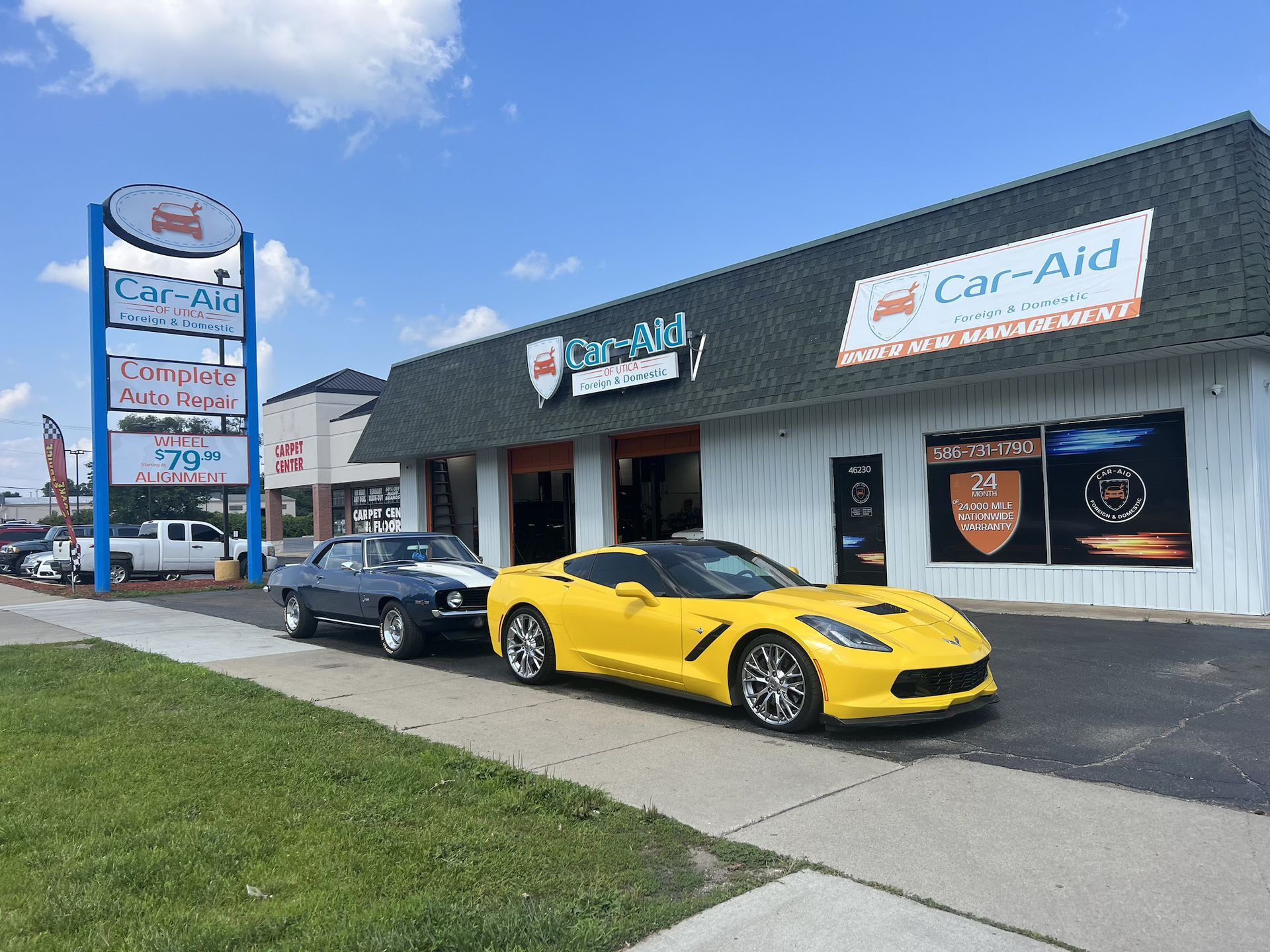 A car repair shop with a sign that says car aid on it