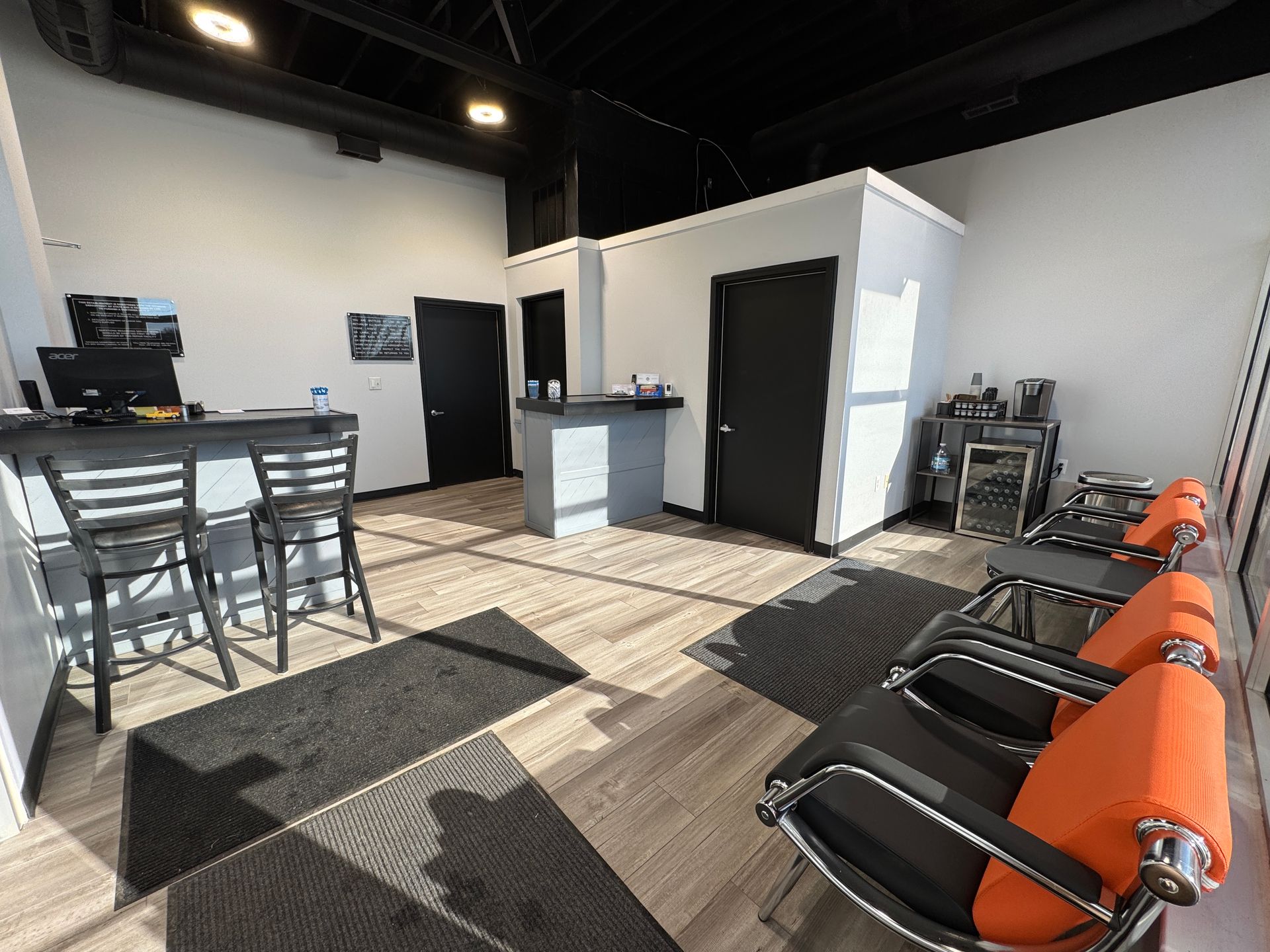 A waiting room with chairs and a counter in a building.