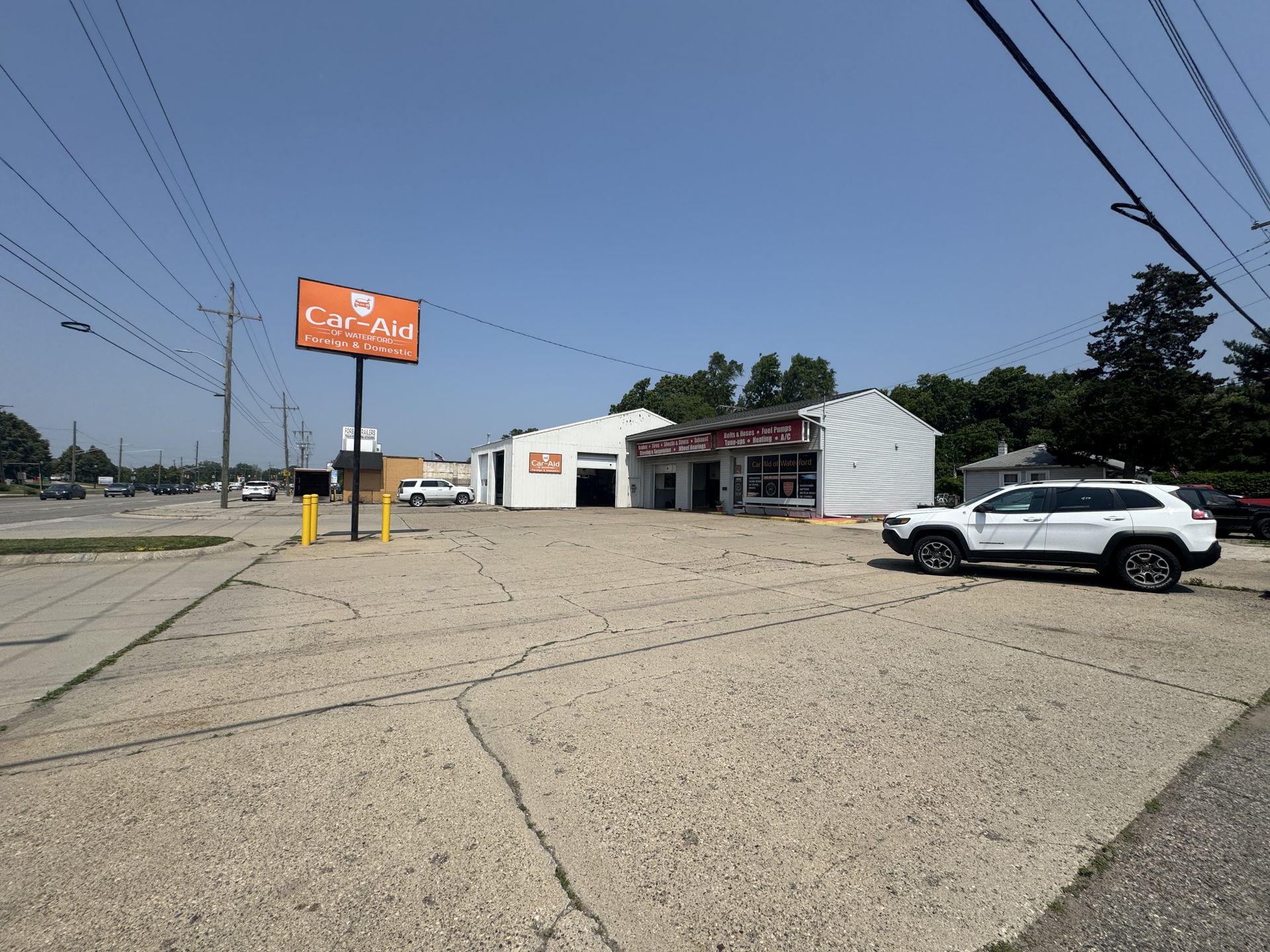 A car is parked in front of a car aid store.