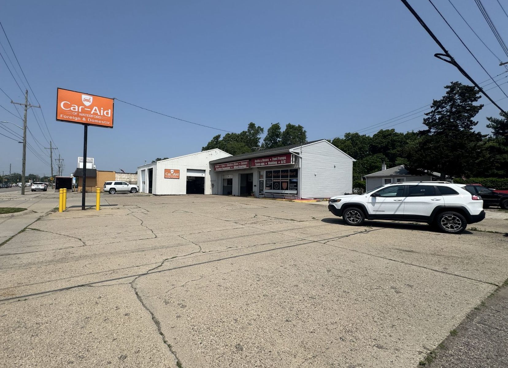 A car is parked in front of a car aid store.
