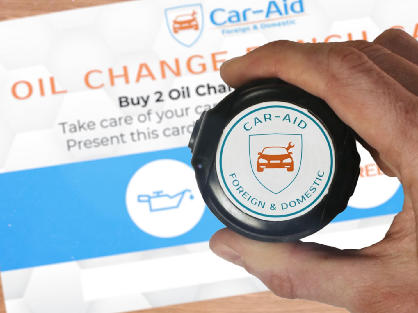 Hand holding a black car oil cap with 