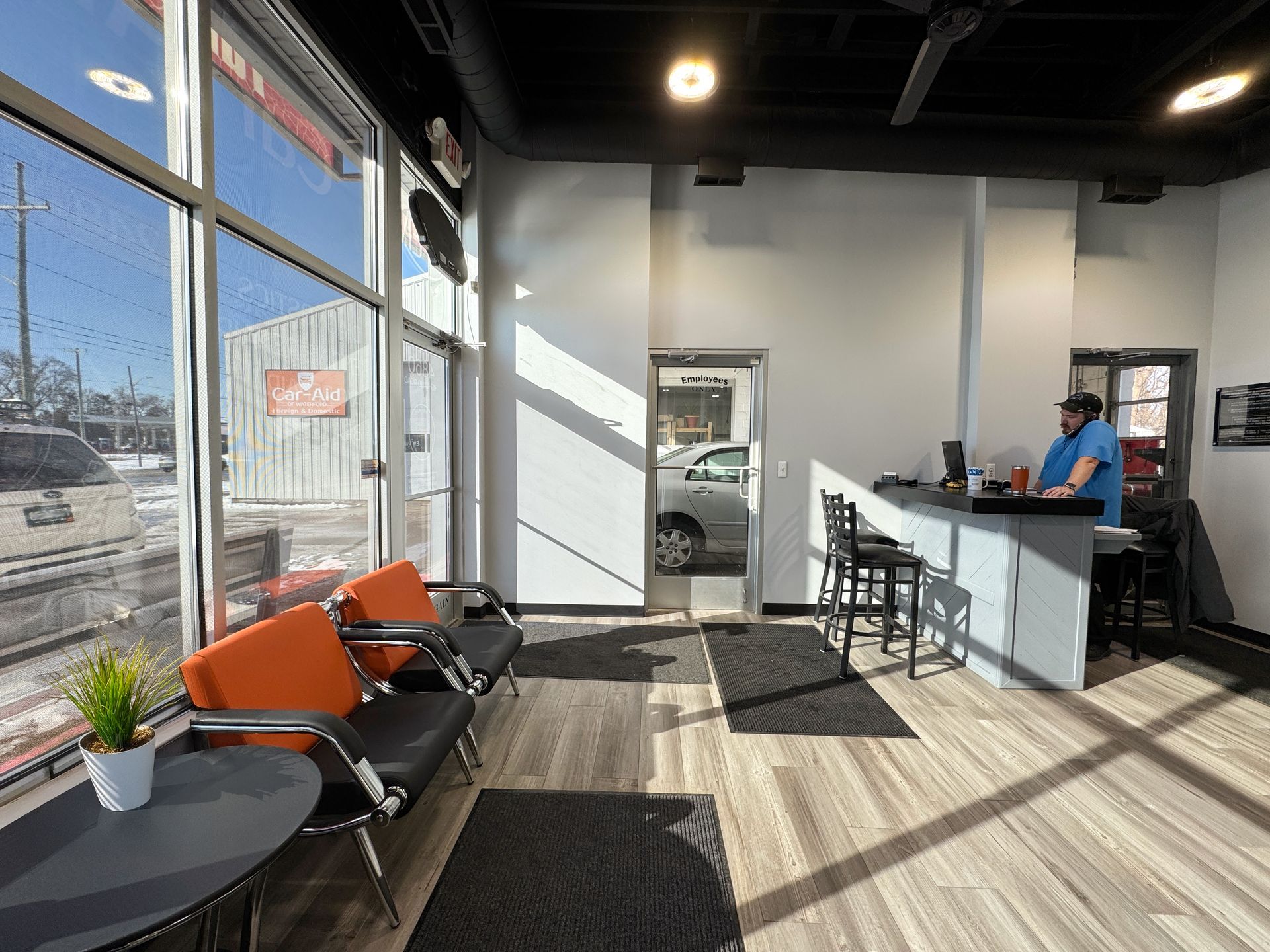 A man is sitting at a counter in a waiting room.