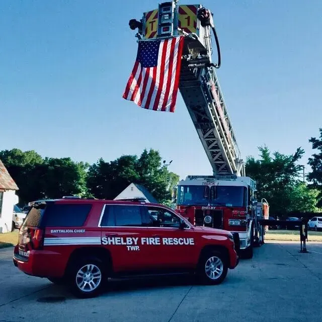 A shelby fire rescue vehicle is parked in a parking lot