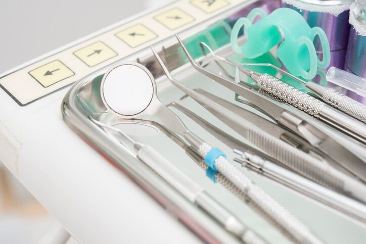 Dental clinic equipment on metal plate — Oral & Maxillofacial Pathology & Surgery Dentists in Tucson, AZ